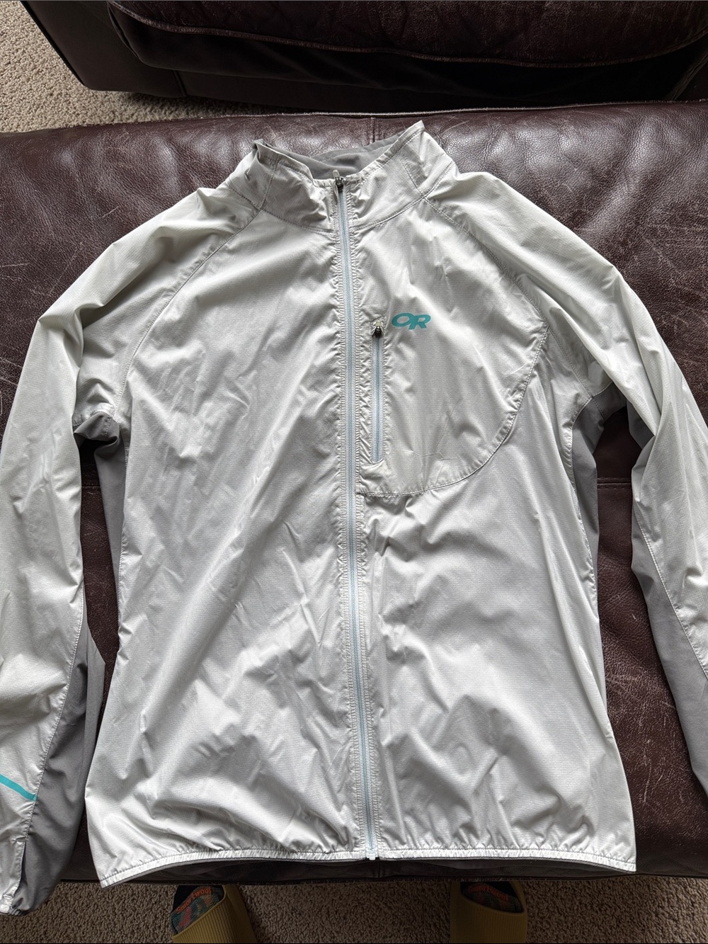 Outdoor Research Light Gray Packable Wind Shell with Teal Logo